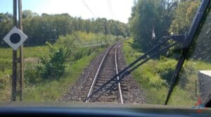 a train tracks with trees in the background