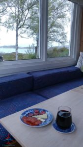 a table with food on it and a glass of wine on it