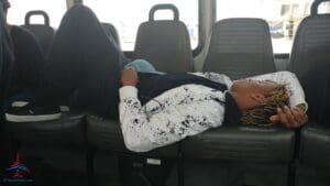 a man lying on a seat