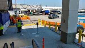 a parking lot with a group of cars and a plane