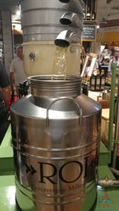 a metal container with liquid being poured into it