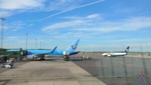 a blue airplane on the tarmac