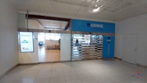 a room with a blue sign and glass doors