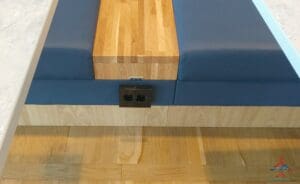 a blue cushion on a wood surface