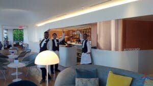 a group of men in white and black uniforms standing in a room