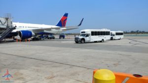 a group of buses and airplanes on a runway