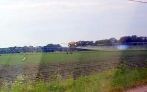 a field with a plane spraying it