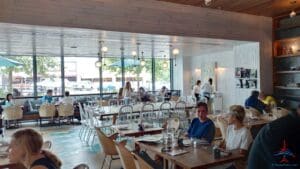 a group of people sitting at tables in a restaurant