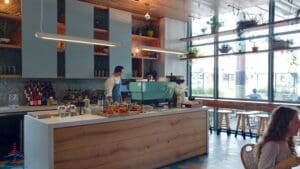 a man standing behind a counter in a restaurant