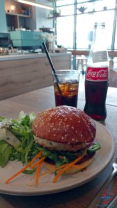 a burger and salad on a plate