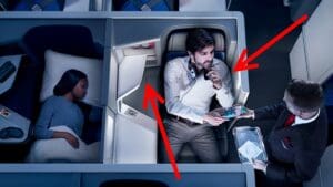 a man sitting in a chair with a microphone and people in the background