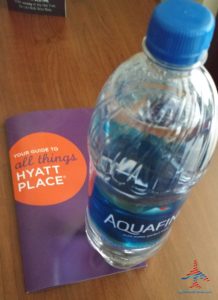 a bottle of water next to a book