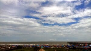 a beach with umbrellas and a body of water