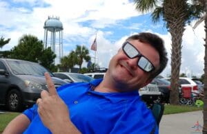 a man wearing sunglasses and pointing his finger