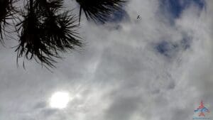 a cloudy sky with a bird flying in the sky
