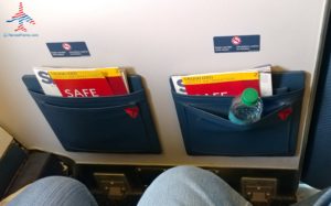 a pair of blue pocket pockets with a bottle of water and magazines