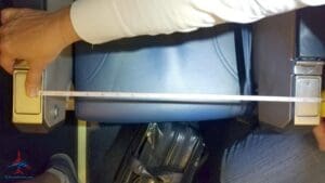 a person measuring a blue plastic container