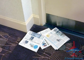 a pile of newspapers on a carpet