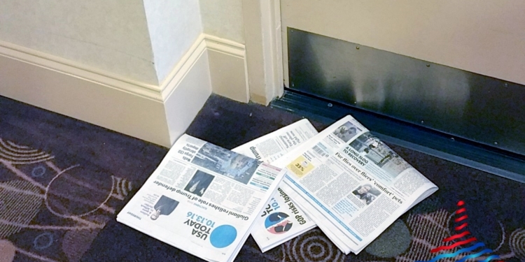 a pile of newspapers on a carpet