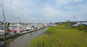 a water channel with boats and grass