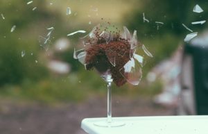 a glass with a brown substance in it
