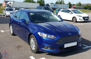 a blue car parked in a parking lot