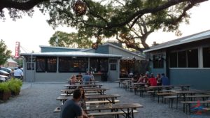 a group of people sitting at tables outside a building