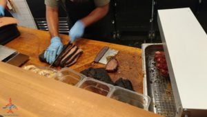 a person cutting meat on a counter