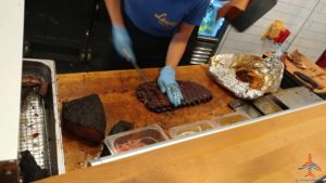 a person cutting meat on a counter