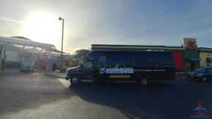 a black bus parked on a road