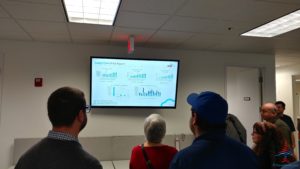 a group of people looking at a screen