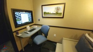 a room with a computer desk and chair