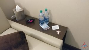 a table with two bottles and a book on it