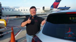 a man standing next to a car