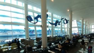 a large room with white pillars and blue objects