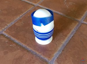 an egg in a cup with tape on it