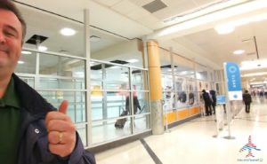 a person giving a thumbs up in a hallway