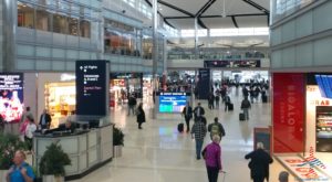 a group of people walking in a large airport