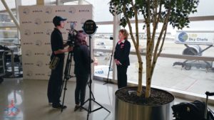a man and woman standing in front of a tree