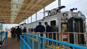 a group of people standing next to a train