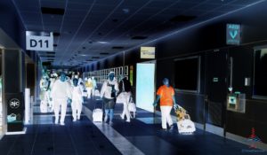 a group of people in white with luggage