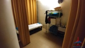 a room with a bed and a shelf