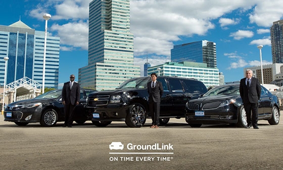 a group of men standing in front of a row of cars