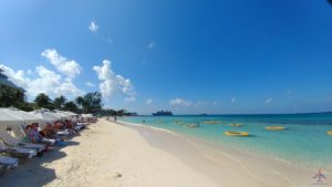 a beach with boats and people on it