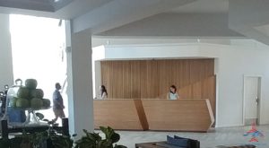 people standing at a reception desk