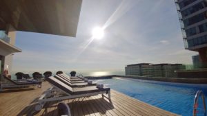 a pool with chairs on a deck