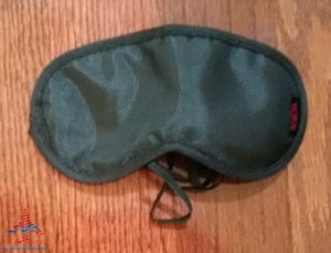 a black eye mask on a wood surface