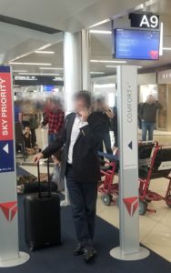 a man standing in a room with a suitcase