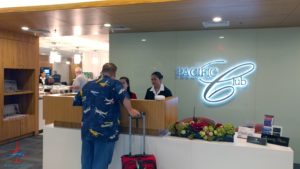 a man with luggage at a reception desk