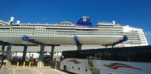 a cruise ship under a bridge